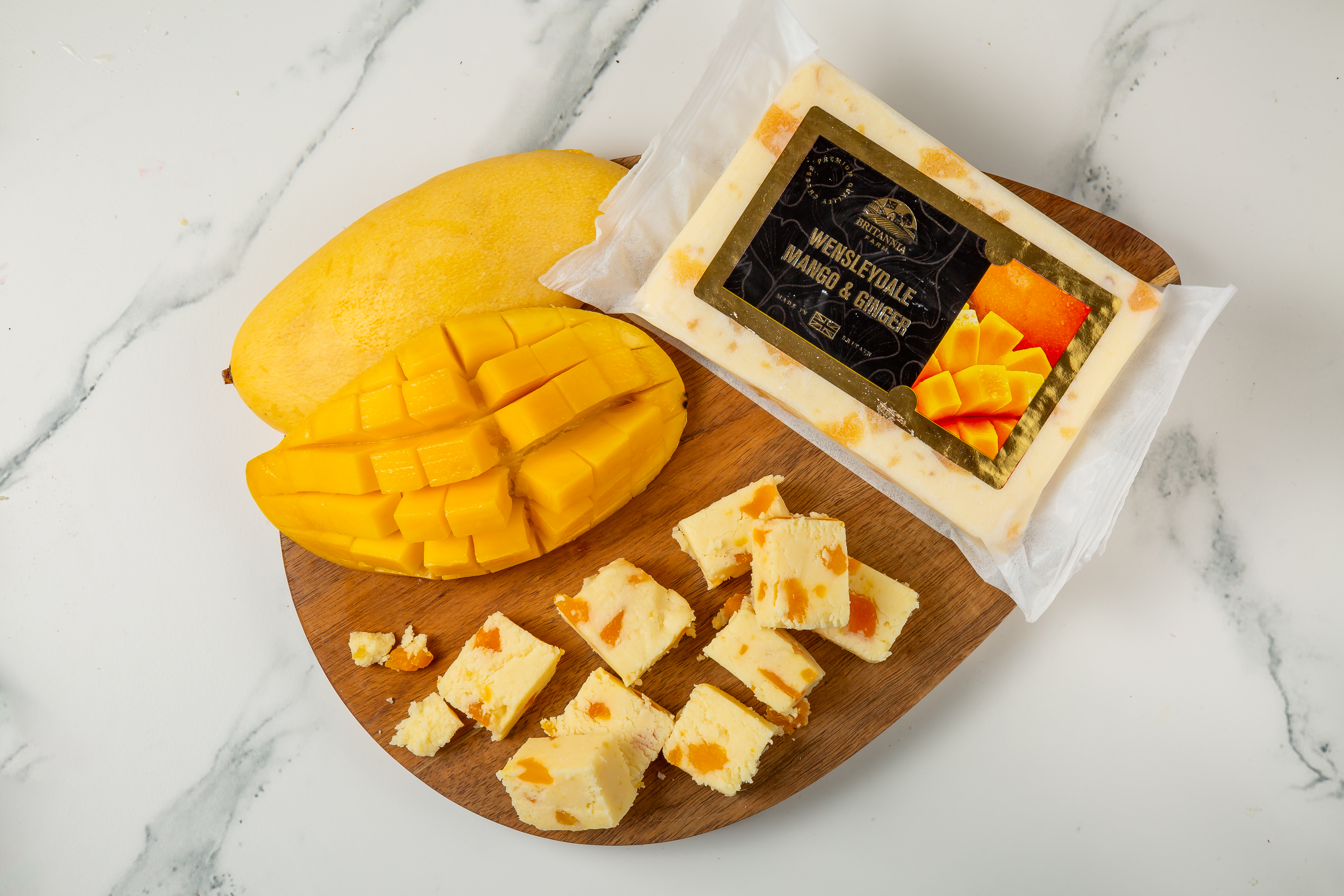 Wensleydale Mango & Ginger cheese block with visible fruit pieces – Britannia Farm